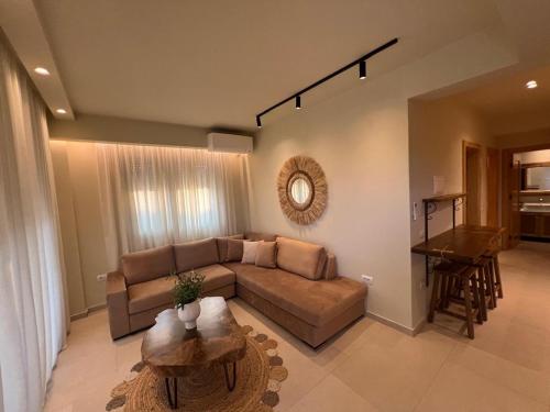 a living room with a couch and a table at Maresol in Nea Kalikratia