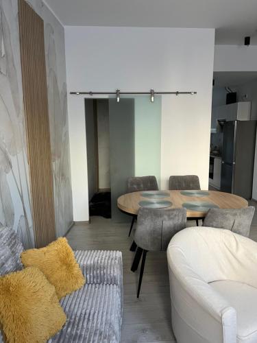 a living room with a table and chairs and a couch at Apartament Olesno in Olesno