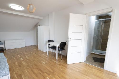 a room with a table and two chairs and a door at Ubytovanie Poloniny in Zboj