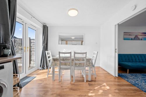 a dining room with a table and chairs at 3BDR Gated parking near city centre in Manchester