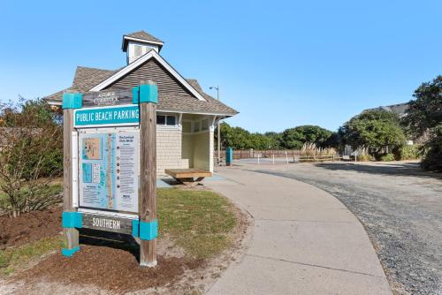 a sign in front of a building next to a sidewalk at Dream Inn in Corolla