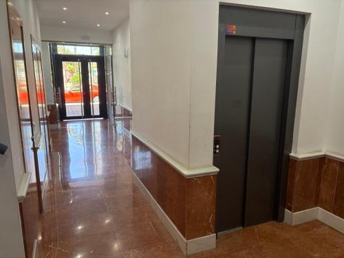 a hallway with a black door in a building at EL RINCÓN DEL GUADALQUIVIR in La Rinconada