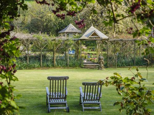 two chairs and a gazebo in a garden at The Barn in Dartmouth