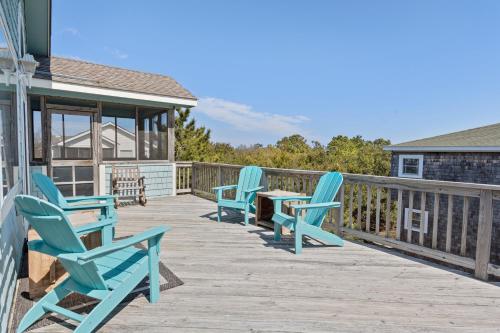 three chairs and a table on a deck at Dream23 in Corolla
