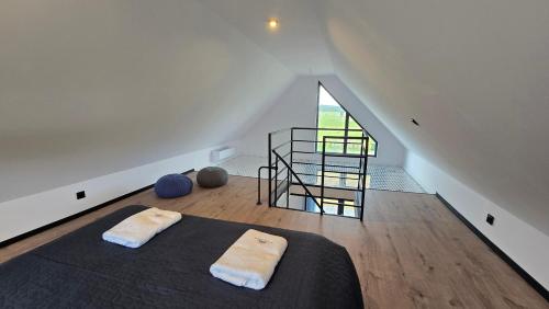 a bedroom with a bed with two white towels on it at Baltic Barns Storm in Wytowno