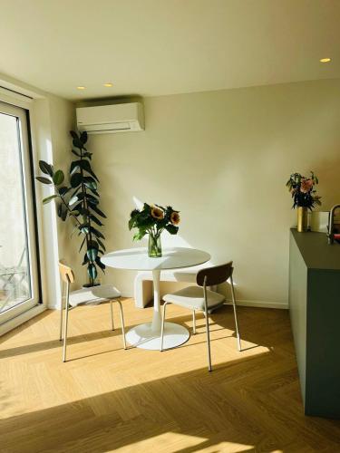 a dining room with a table and two chairs at Leaf Holiday Studio Kortrijk in Kortrijk