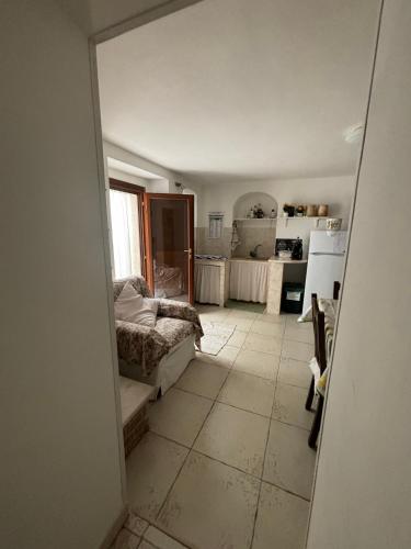 a living room with a couch and a kitchen at La Casetta in Ischitella