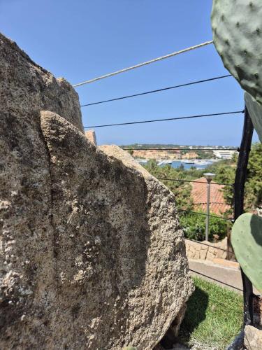 a large rock with a view of a city at Casa Alessandra, Apartment in Porto Cervo in Porto Cervo