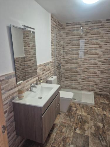 a bathroom with a sink and a toilet at Luz del Mar in Orzola