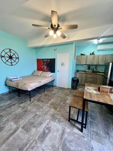 a bedroom with a bed and a ceiling fan at Ocean View House in Quebradillas with Rooftop 