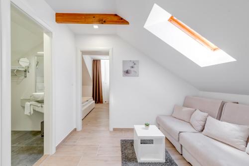 a white living room with a couch and a table at Apartments Villa Tudor 2 in Hvar