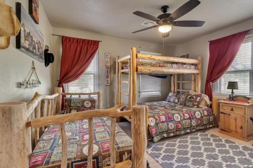 a bedroom with two bunk beds and a ceiling fan at Lakeside Retreat And Game Haven in Eufaula