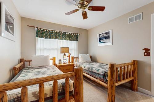 a bedroom with two beds and a ceiling fan at Beacon Court Condo F in Douglas