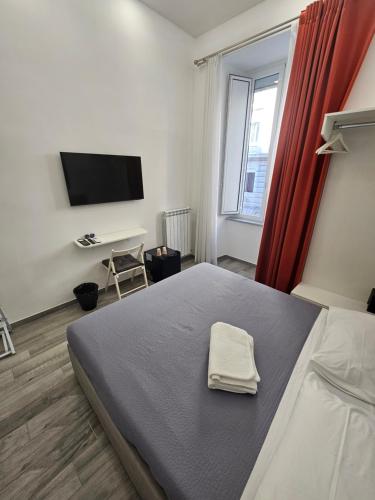 a bedroom with a bed with a towel on it at B&B Il Regno delle Due Sicilie in Naples