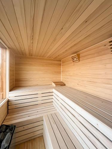 an empty wooden sauna with wooden floors and ceilings at Bujtina Adora in Ara të Lumit
