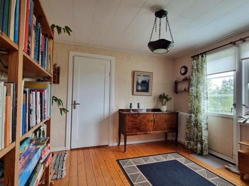 a room with a door and a desk and a window at Huset Solhem in Resta