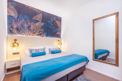 a bedroom with a bed and a mirror at Mare & Monti in Mlini