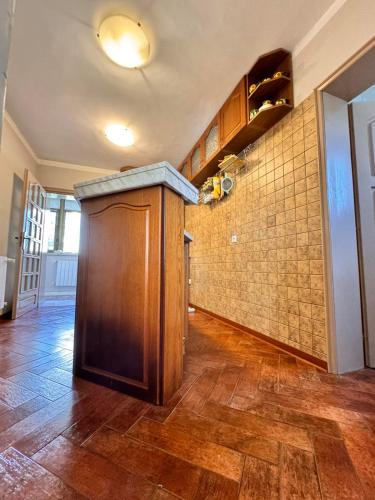 a room with a wooden door and a tile wall at Къща за гости Заркови in Gaber