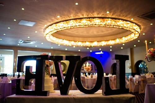 a sign that says love on a table in a restaurant at The Bold Hotel; BW Signature Collection in Southport