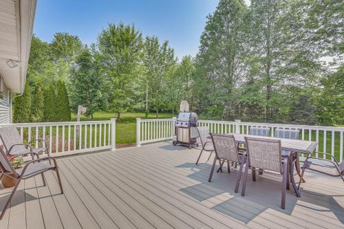 a wooden deck with a grill and chairs on it at Fish, Hike and Golf Leisurely Navarre Home with Yard! in Navarre