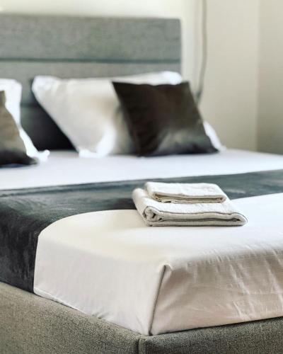 two beds with white towels on top of them at Antonios Apartments in Ulcinj