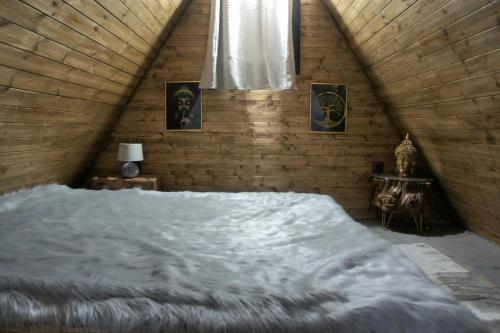 a bedroom with a large white bed in a attic at Villa India A-Frame in Ledenik
