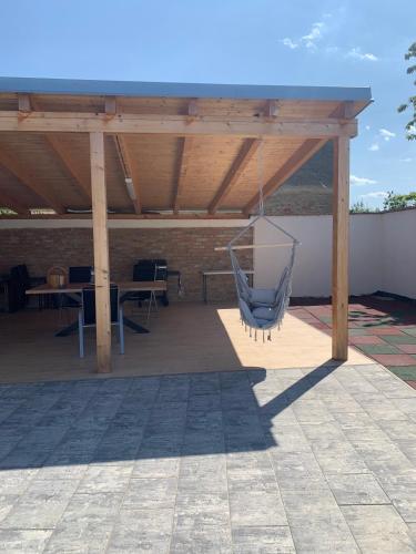 a patio with a hammock hanging from a pavilion at Chalupa U Studny in Jaroslavice