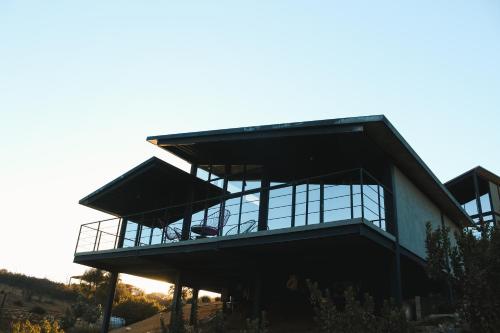 a large building with a glass facade at Origen75 Loft - Villas - Skypool - Viñedo, Valle de Guadalupe in Valle de Guadalupe