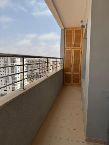 a balcony with a door and a view of a city at Panoramic Family Apartment Agadir New in Agadir