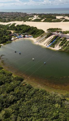 an aerial view of a body of water with boats at Riviera dourada - Casa Pôr do Sol in Jacumã