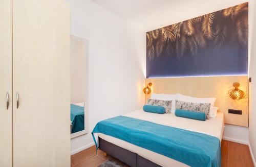 a bedroom with a bed with blue and white at Mare & Monti in Mlini