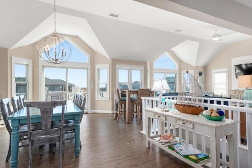 a kitchen and dining room with a table and chairs at Fish Tank in Corolla