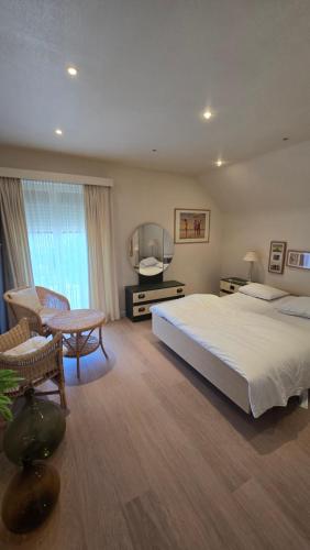 a large bedroom with a bed and a television at Sea Home in Middelkerke