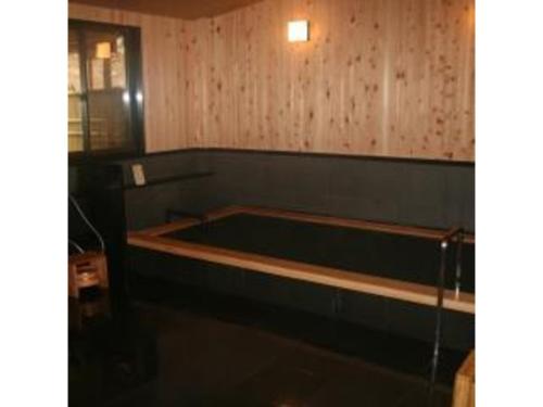 a large bath tub in a room with wooden walls at Yumoto Onsen OharaSansou - Vacation STAY 27617v in Kyoto