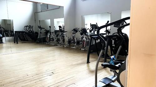 a gym with many bikes in a room with mirrors at Rentalux Hostel - Modern Comfort, Single Rooms in Timrå