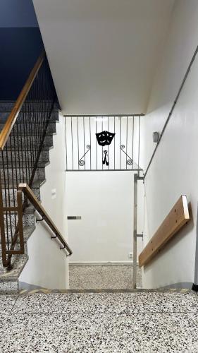 a staircase with a door with a stained glass window at Rentalux Hostel - Modern Comfort, Single Rooms in Timrå