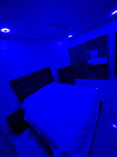 a blue room with a bed and a tv at Luxury apartment in Tangier in Tangier