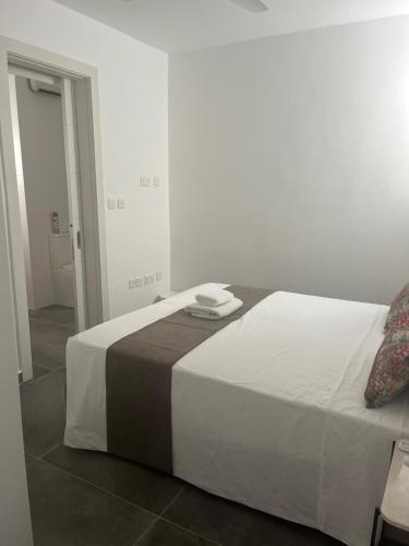 a bedroom with a large white bed in a room at GOZO DIVE Residence in Xlendi
