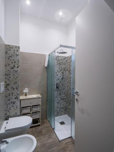 a bathroom with a shower and a toilet and a sink at Nonna Palmina in Crispiano