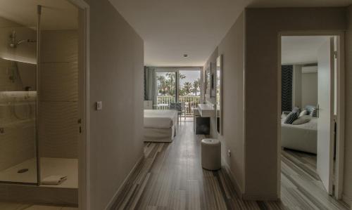 a living room with a bedroom and a bathroom at Hôtel Josse in Antibes