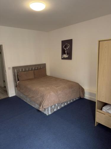 a bedroom with a large bed in a room at Central Wigan Stay in Wigan