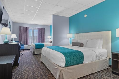 Ein Bett oder Betten in einem Zimmer der Unterkunft Elevation Inn & Suites, Trademark Collection by Wyndham