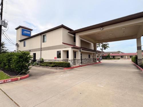 an empty parking lot in front of a building at Americas Best Value Inn Houston Veterans Memorial in Houston