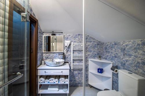 a bathroom with a toilet and a sink at Green Garden Guesthouse in Tbilisi City