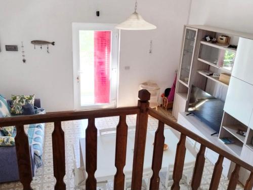 a room with a staircase and a window at Summer Holiday - Torre Vado in Torre Vado