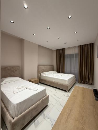 two beds in a hotel room with two bedsvisor at Azure Waves in Vlorë
