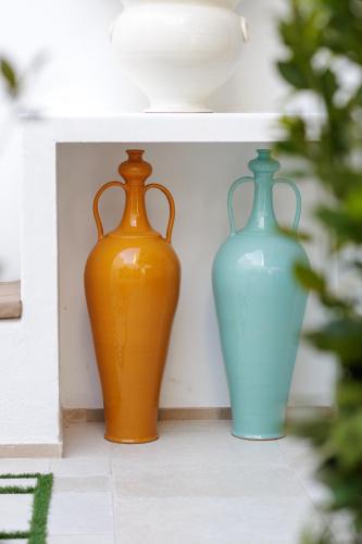 three vases sitting on a shelf next to each other at AGLEA trulli e suite in Alberobello