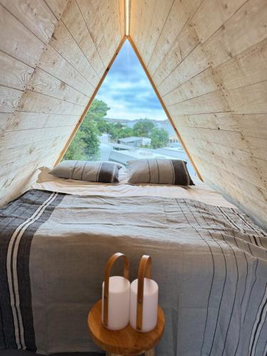 a bedroom with a bed with a large window at Saltviks Stugby & Camping in Grebbestad