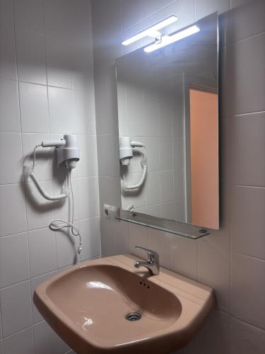 a bathroom with a sink and a mirror at El Rinconin I in Cangas de Onís