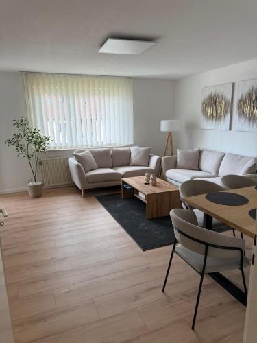 a living room with a couch and a table at FMA Ferienwohnung Schönblick in Schwäbisch Gmünd